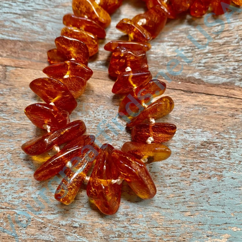 Is this real Baltic Amber? Necklace is 98 g. Glows under UV light. Can't do  the smell test because I have a terrible sense of smell lol. No clasp,  individually knotted. I've